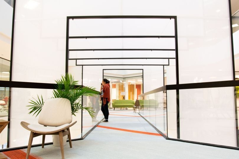 75F office hallway with woman standing look out the window